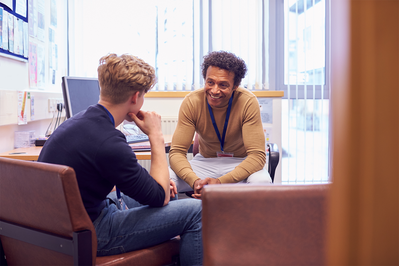 Instructor helping student in office